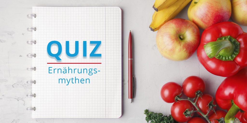 Schreibblock mit dem Text Quiz Ernährungsmythen, recht daneben verschiedene Obst- und Gemüsesorten